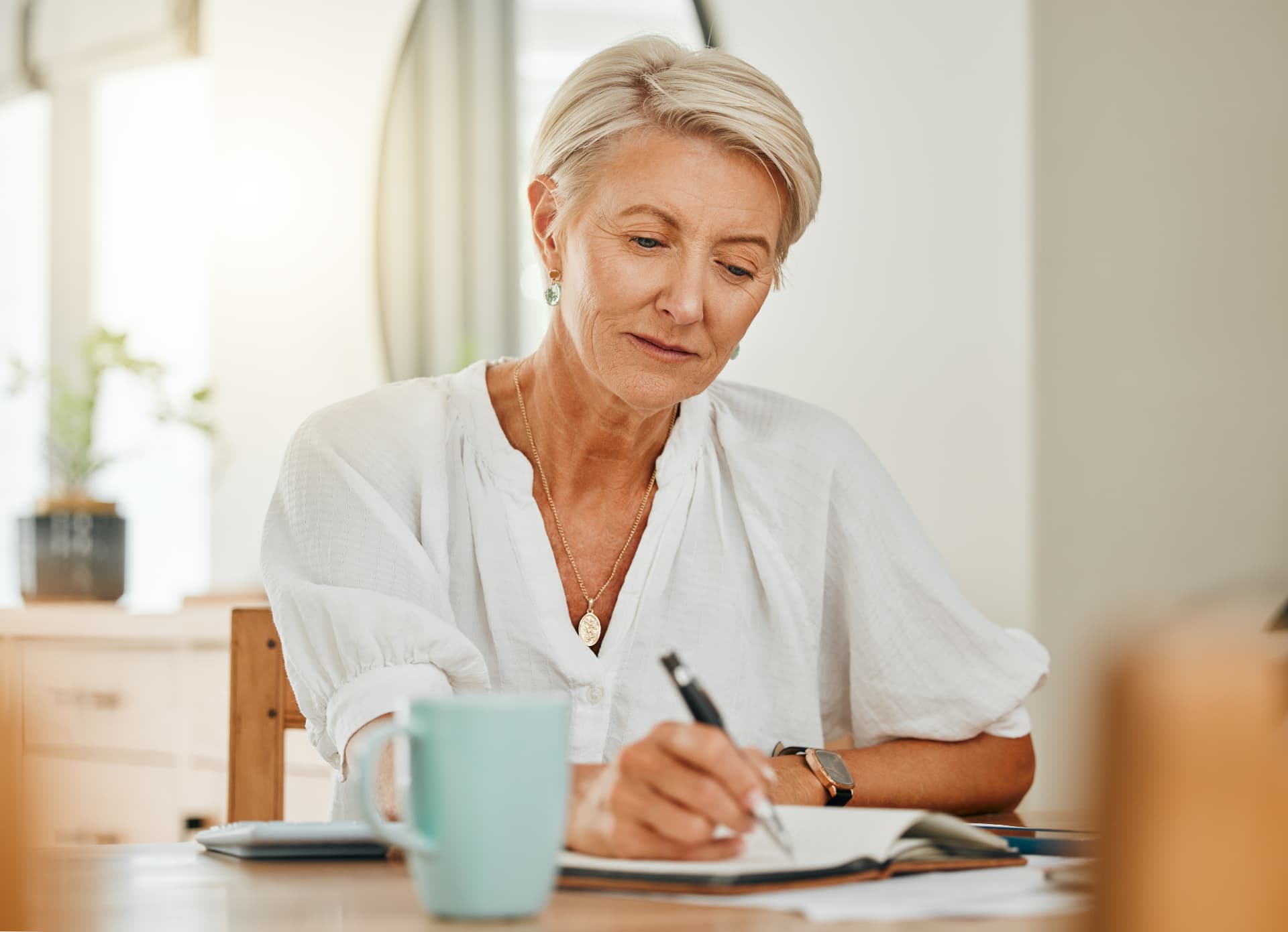Woman reviewing personal legal and estate planning documents at home following separation.
