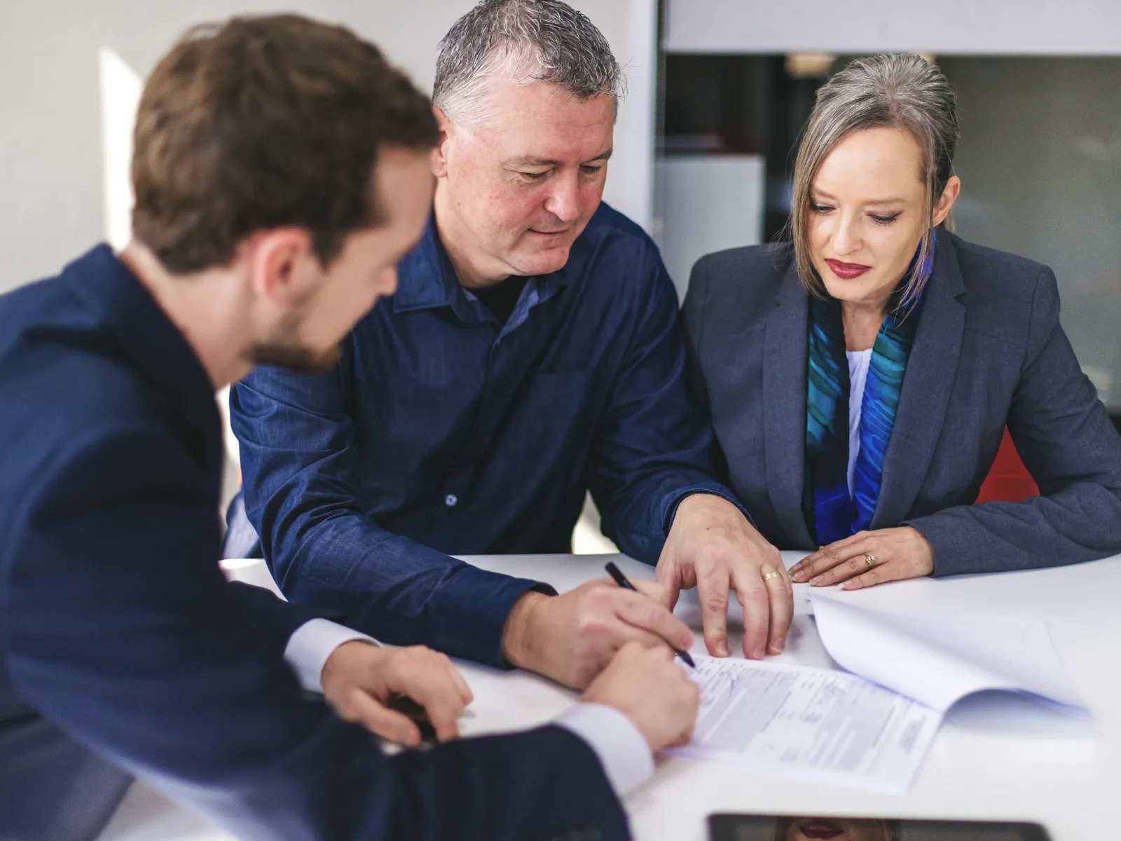 A Parke Lawyers litigation team and a client working through the strategy in a dispute matter at a meeting table