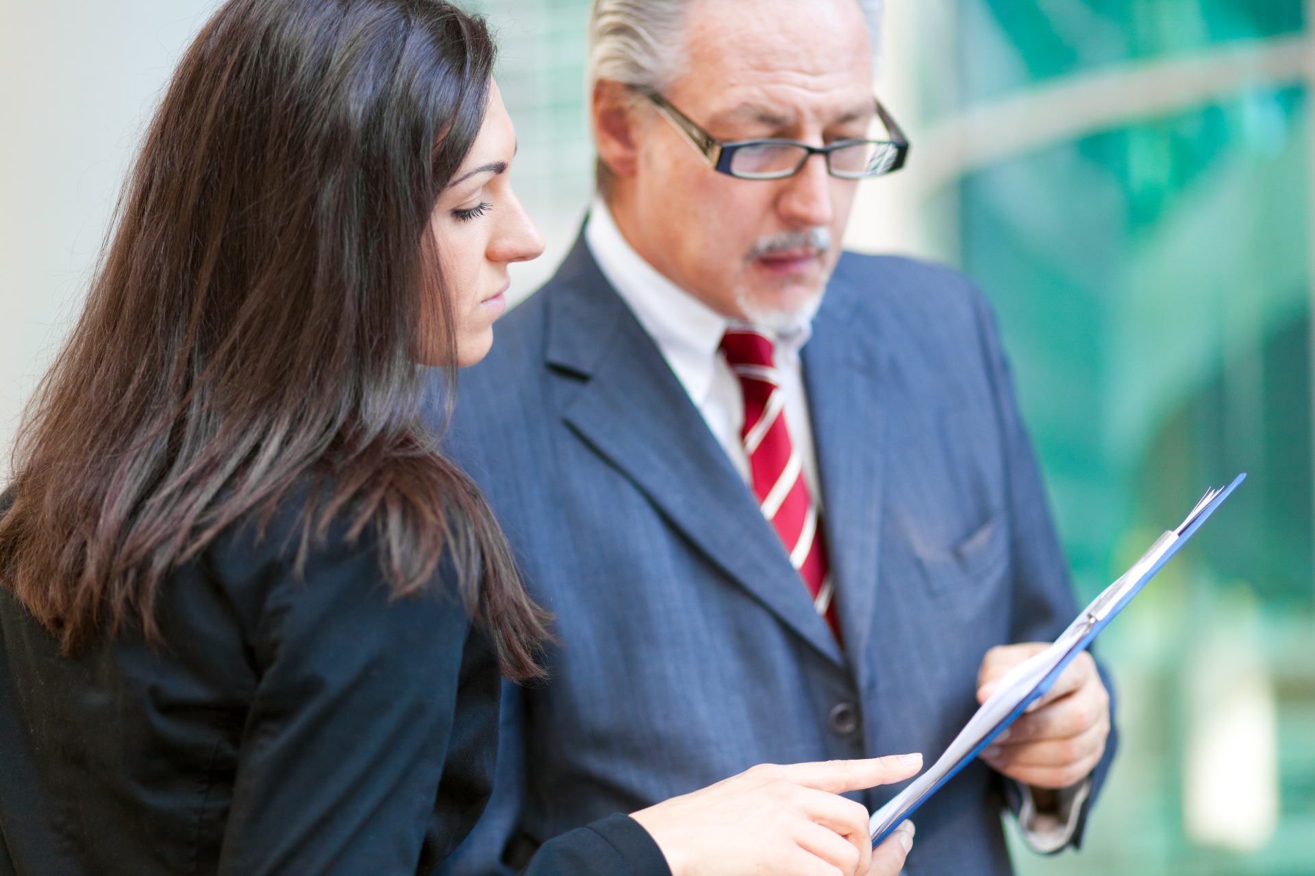Two co-executors reviewing estate administration documents and discussing decisions together