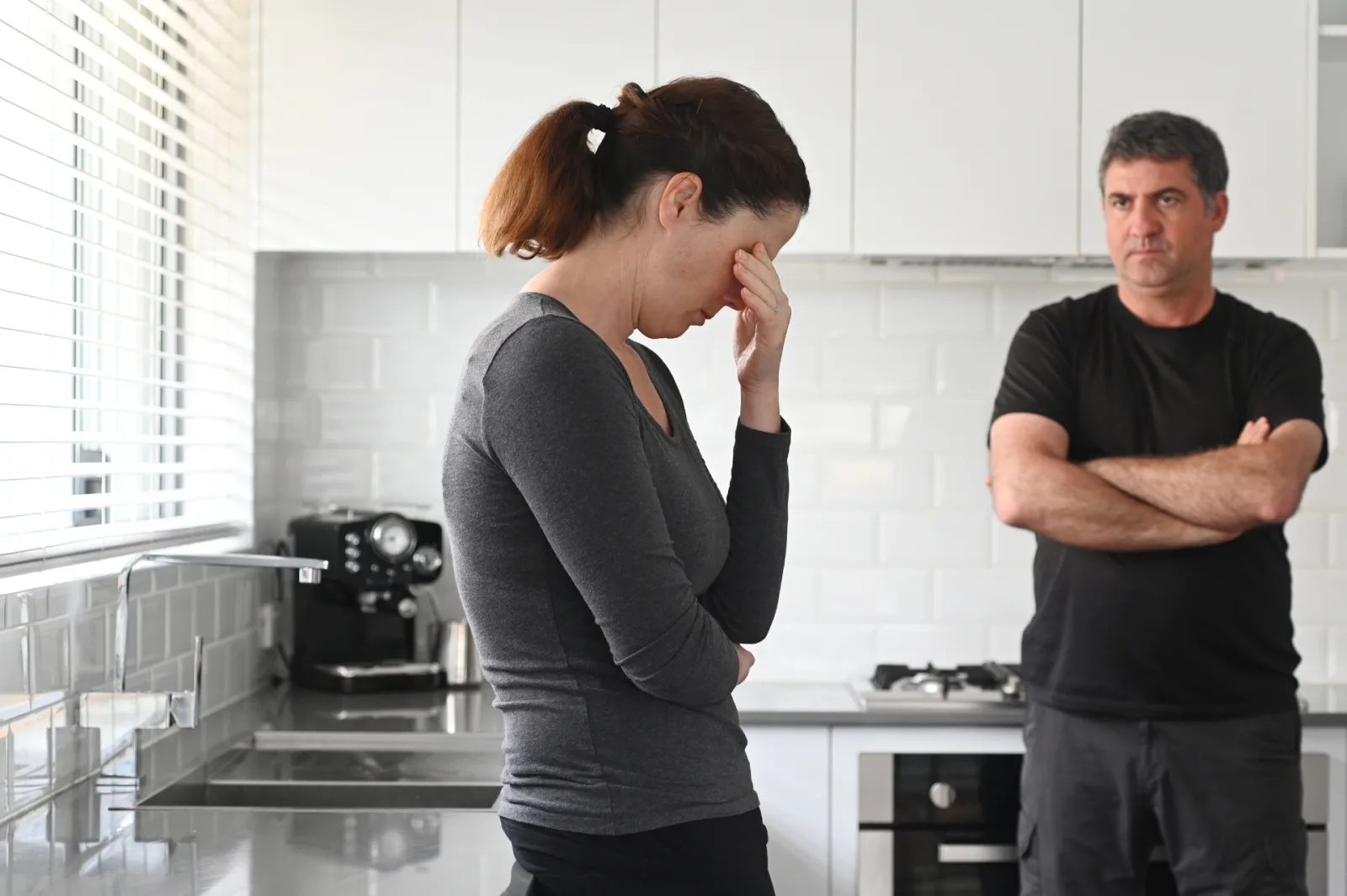 Separated couple in a family home, illustrating the breakdown of a relationship and the divorce process in Australia.