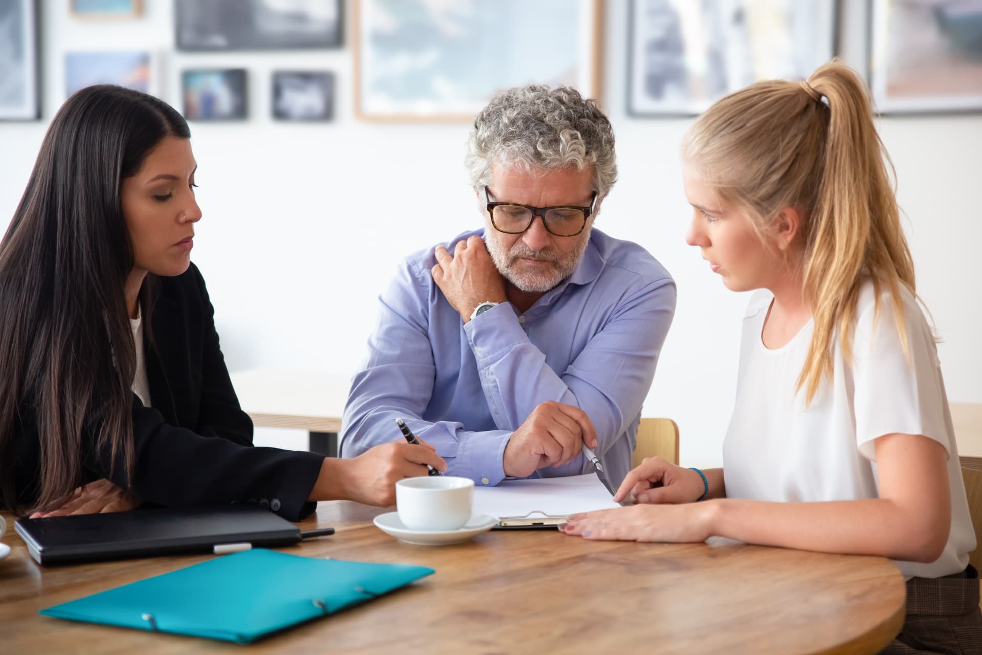 Business owners reviewing sale documents with a professional adviser