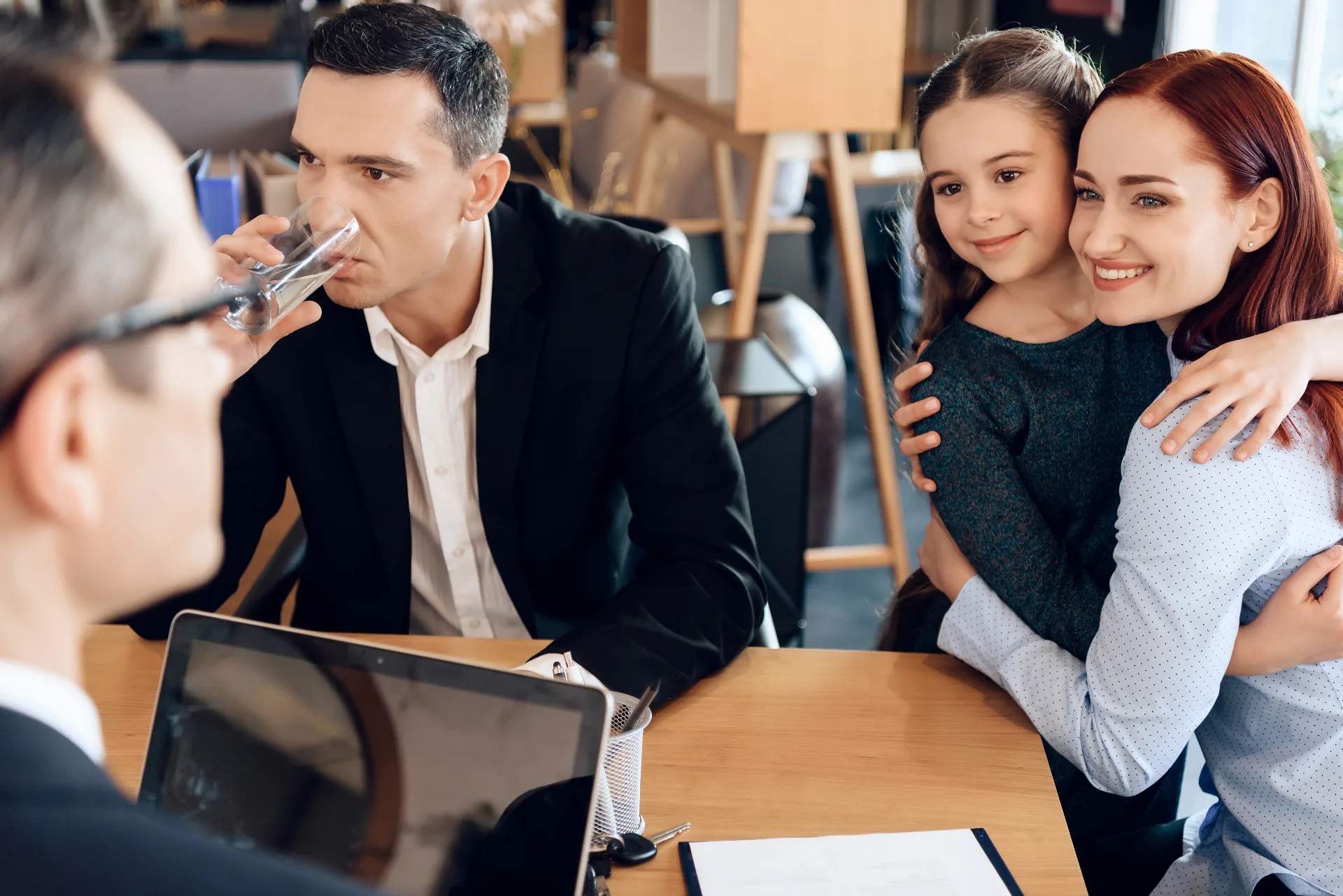 Separated parents and their child meeting with a family law adviser to discuss child support arrangements and financial responsibilities.