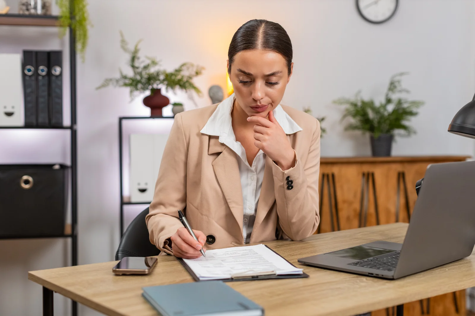 A business professional reviews contract documents at a desk — unfair contract terms in Australian business contracts