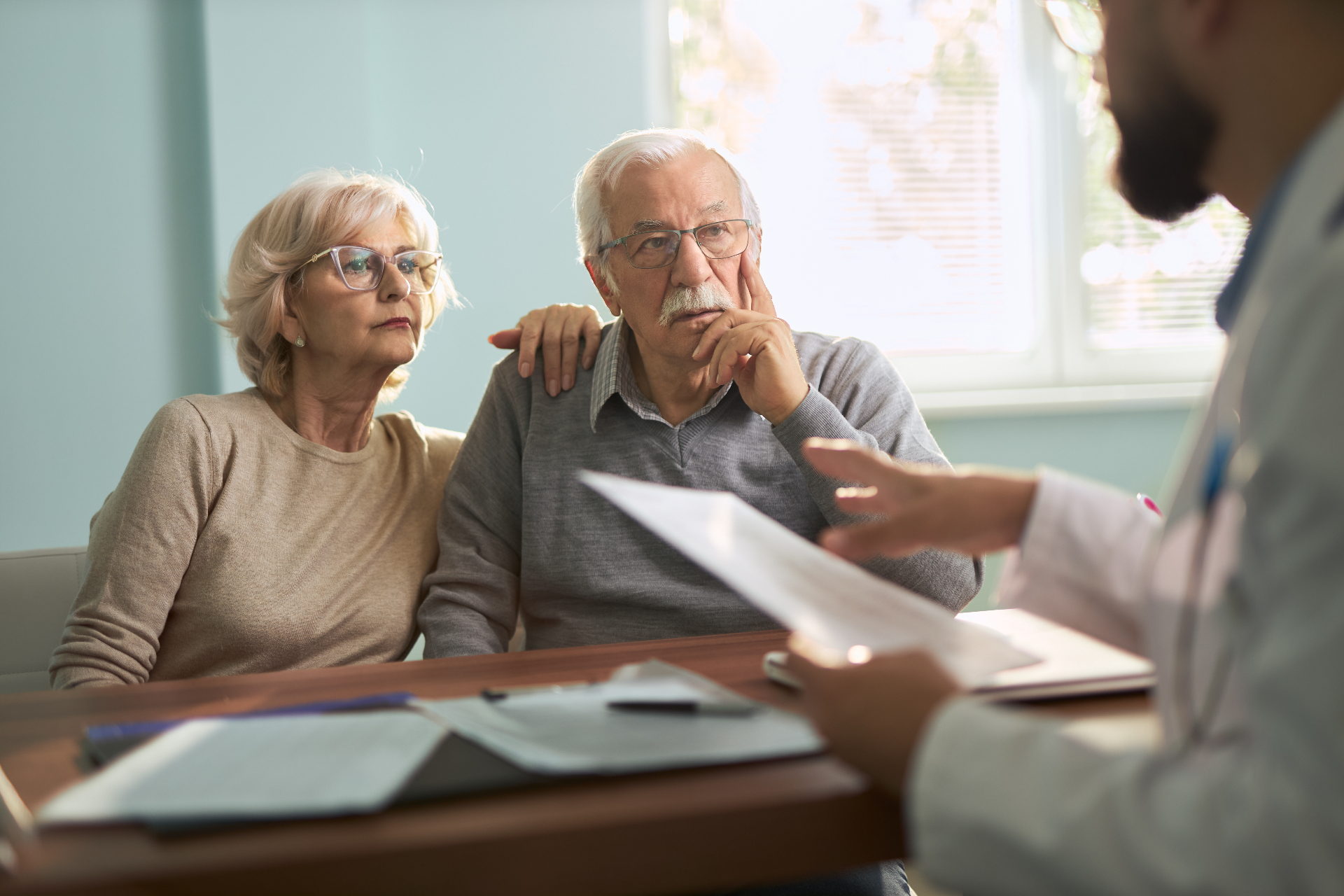 Older couple discussing wills and estate planning with a lawyer