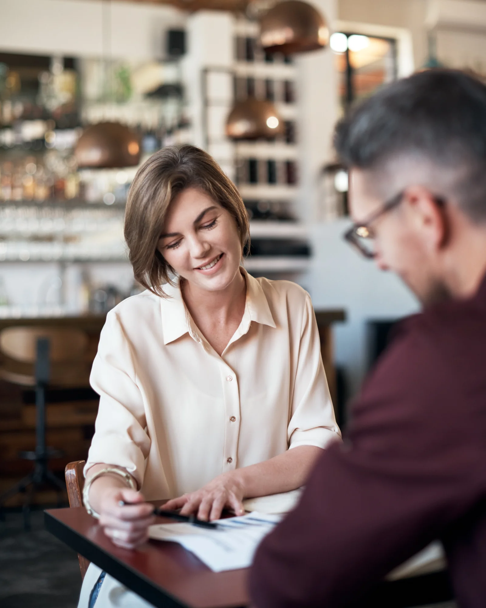 A Parke Lawyers commercial lawyer meeting with a business owner, reviewing documents together at a table