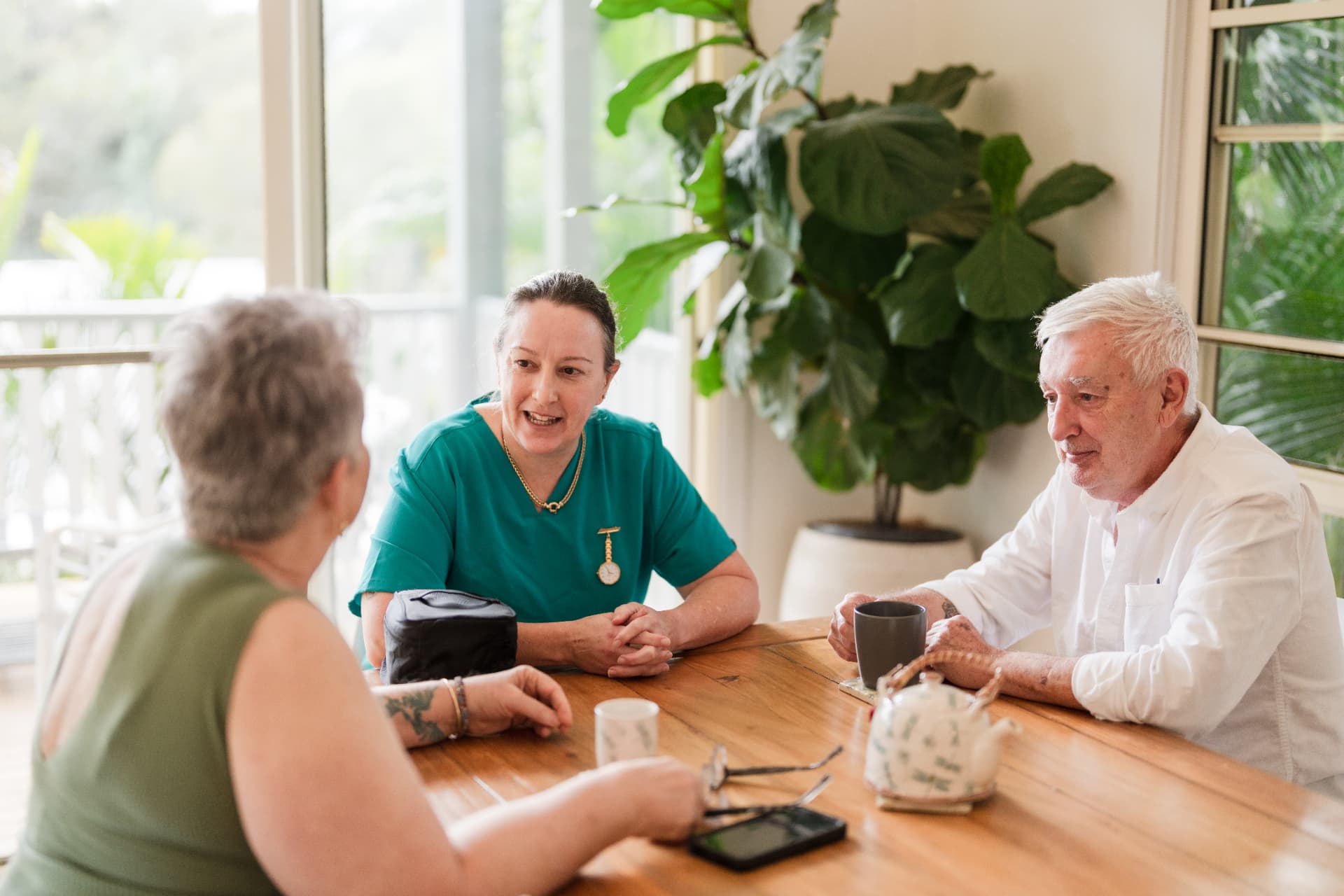 Older couple discussing their aged care choices with a care professional at home