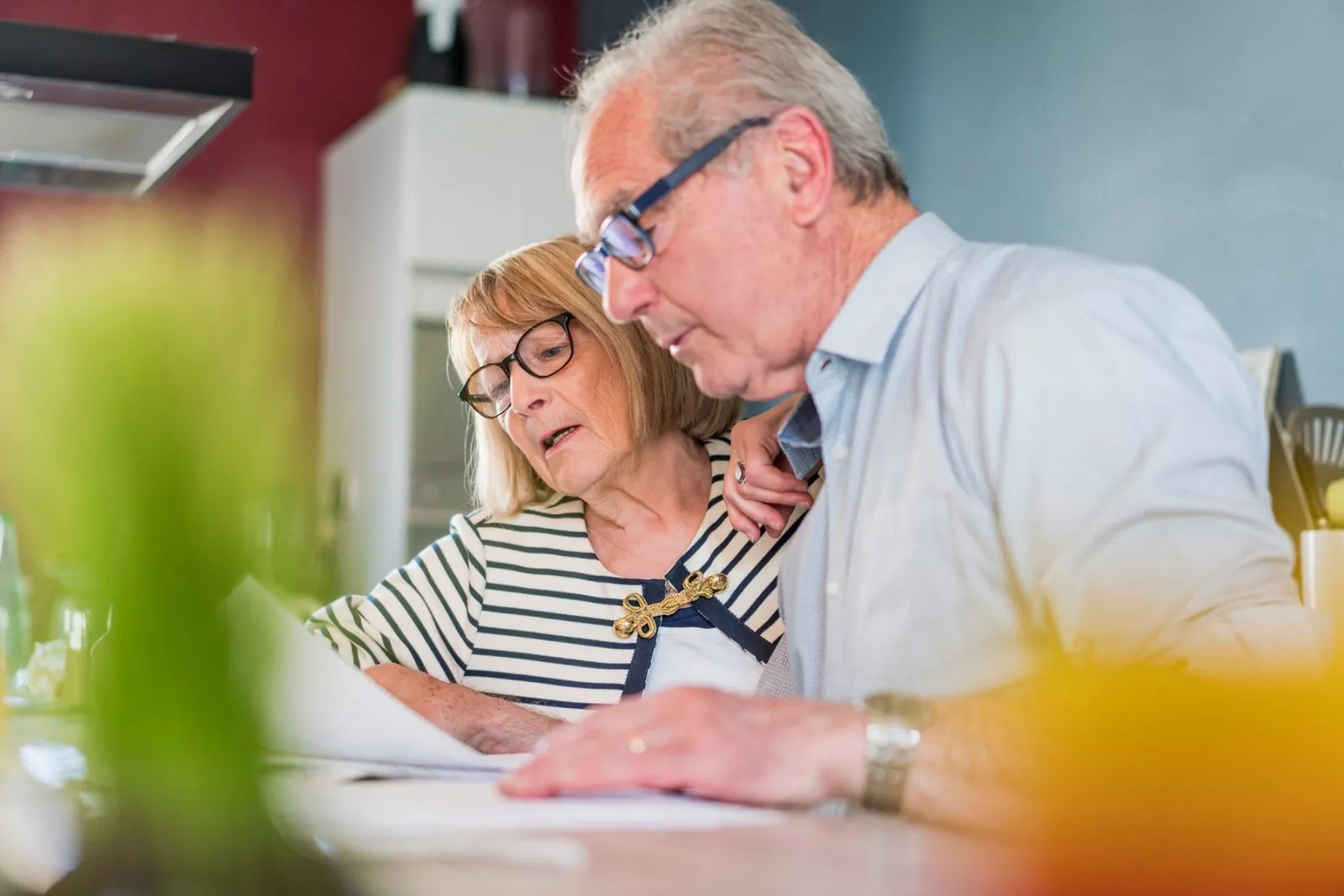 Senior couple reviewing estate planning documents together at home