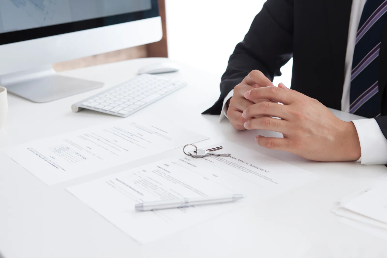 Property documents, keys and contract of sale on a lawyer's desk during a client review