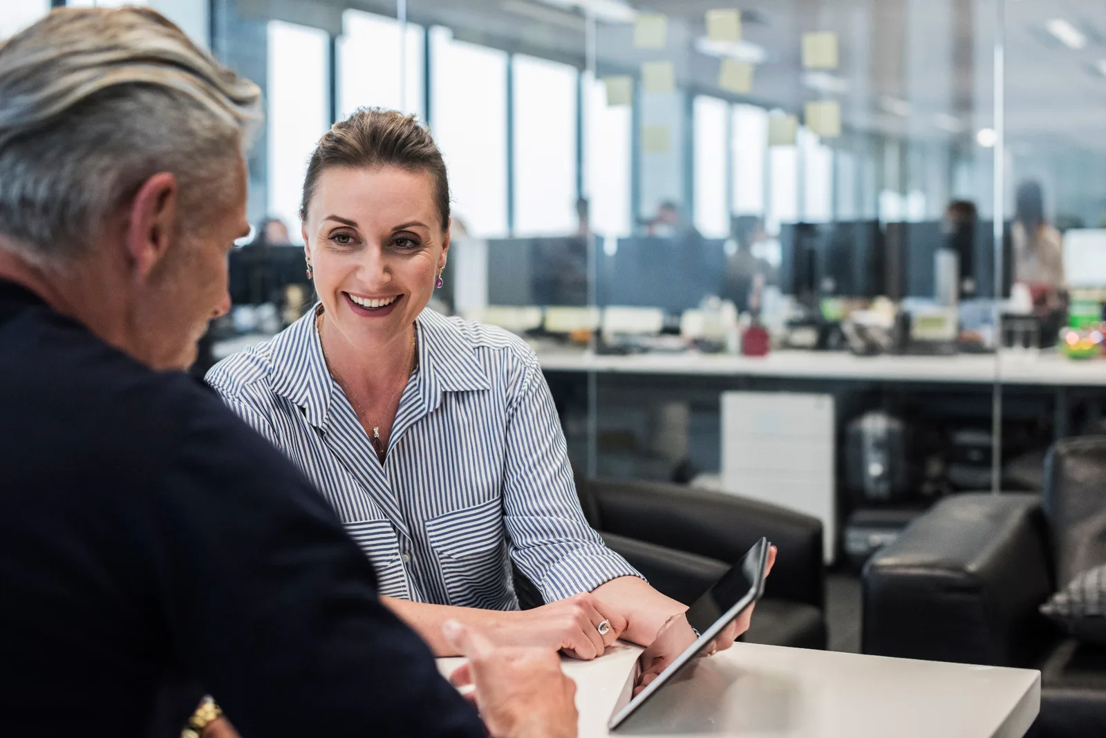 A Parke Lawyers property lawyer reviewing a transaction on a tablet with a client in a Melbourne office