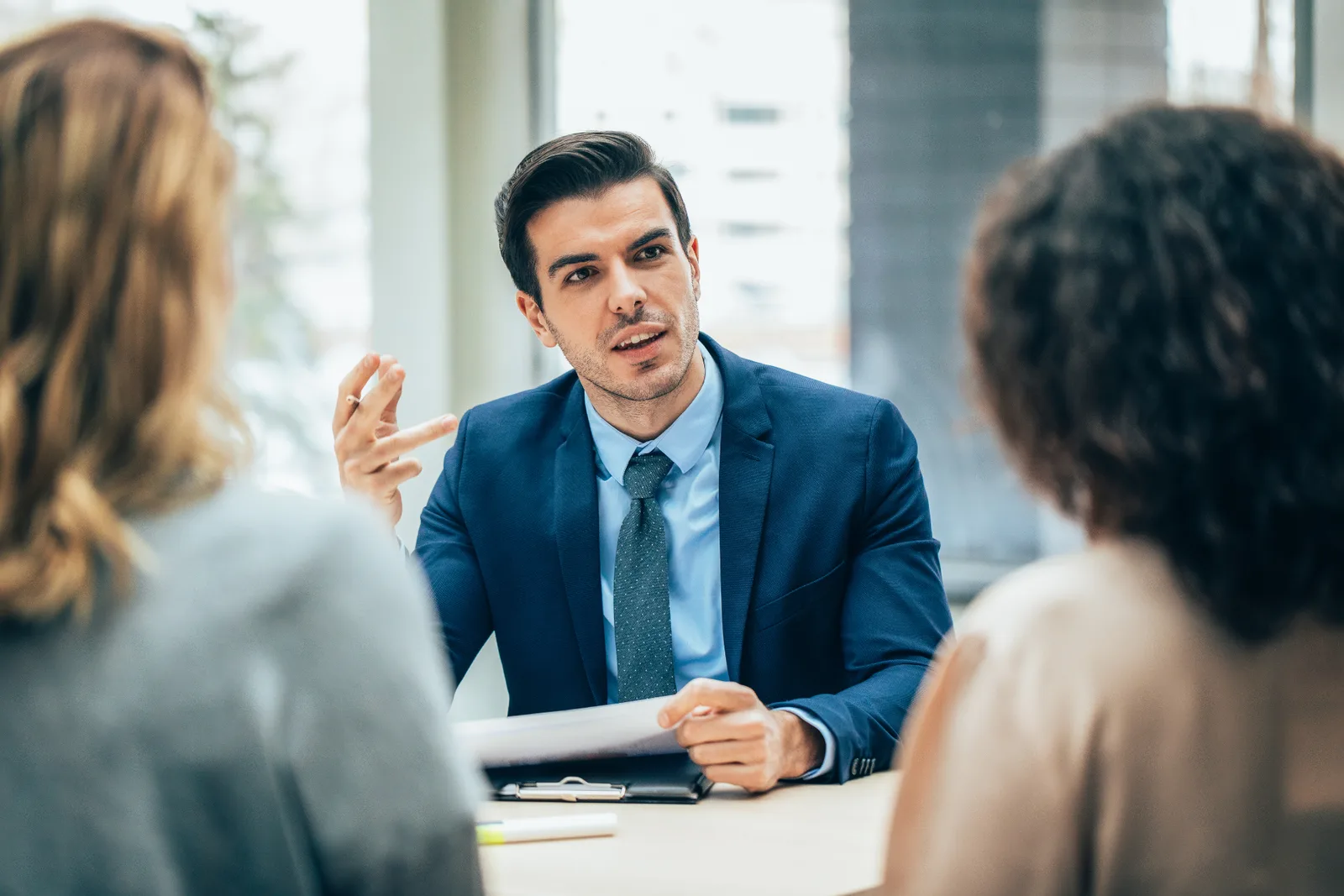 A Parke Lawyers estate litigation lawyer in a measured, confidential conference with two clients in a private meeting room