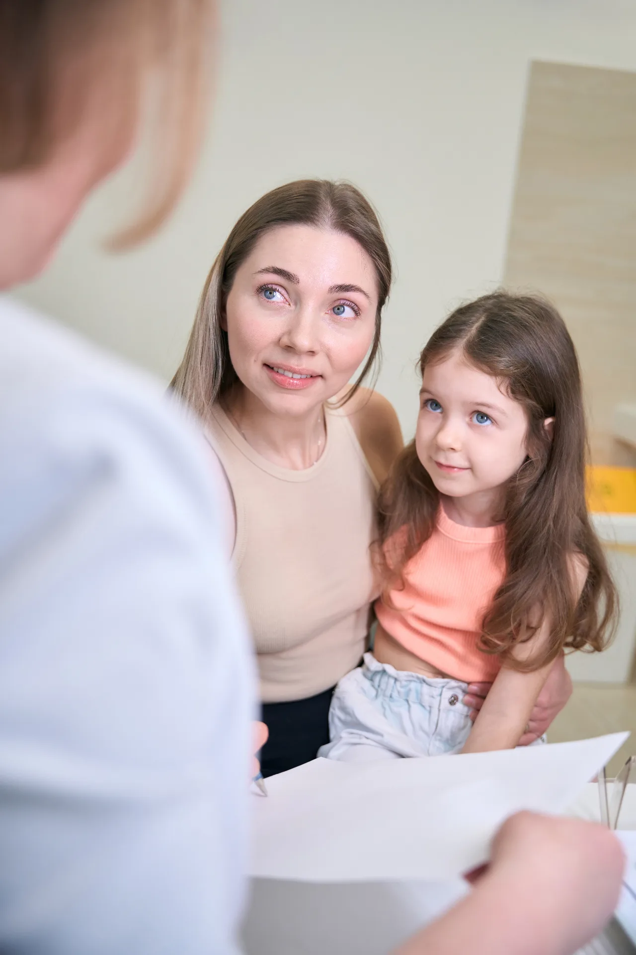 Mother holding her young daughter during a confidential consultation with a Parke Lawyers family lawyer